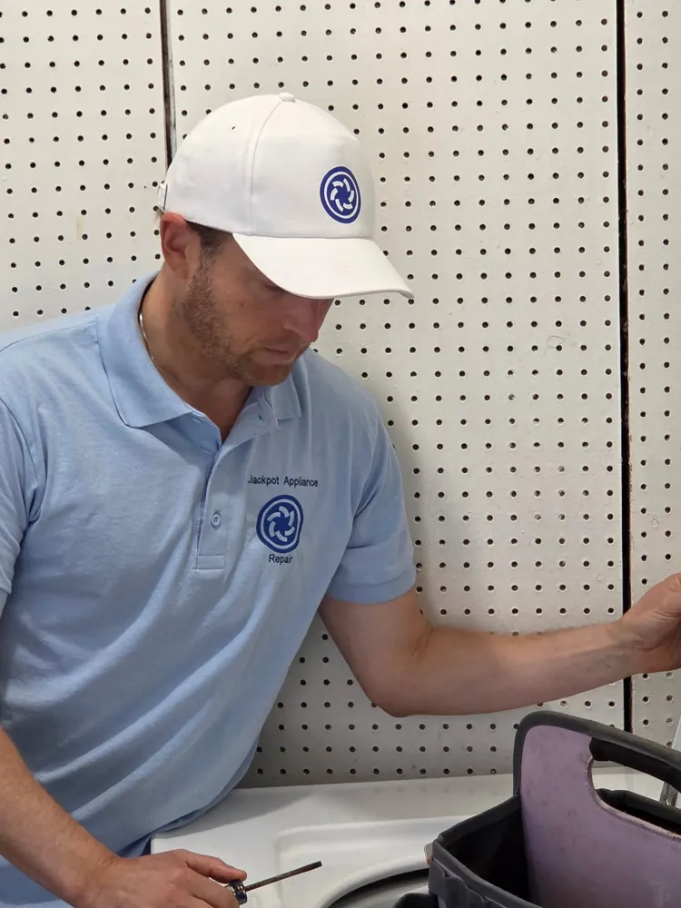 Jackpot Appliance Repair technician working on a washer